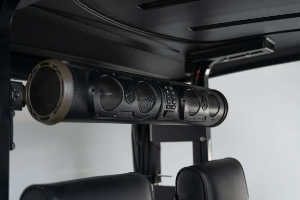 Close-up of a car's overhead console with air vents and controls.