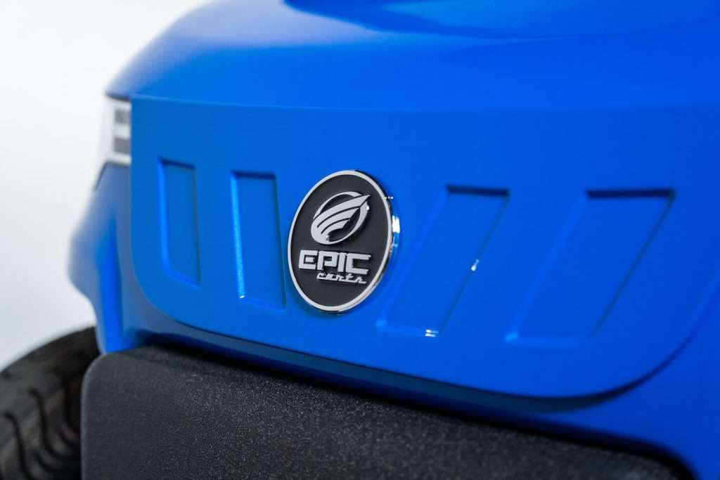Close-up of an Epic logo on a blue surface.