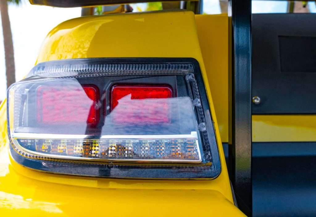 Close-up of a yellow vehicle's rear brake light.