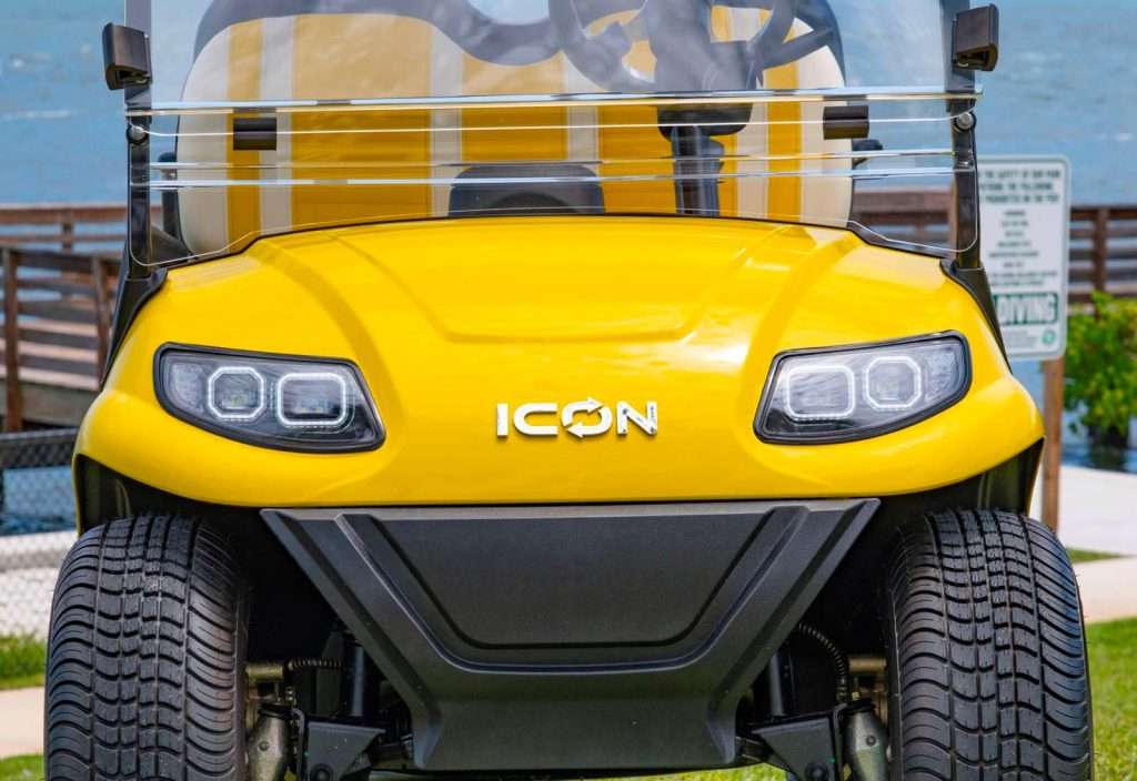 Front view of a yellow ICON vehicle with distinctive headlights.