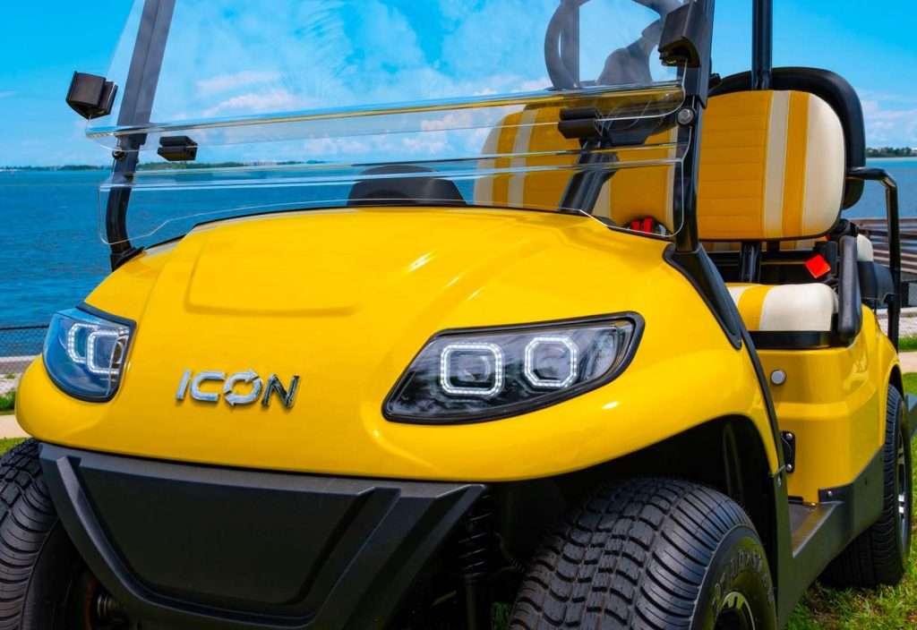 Close-up of a yellow Icon electric golf cart.