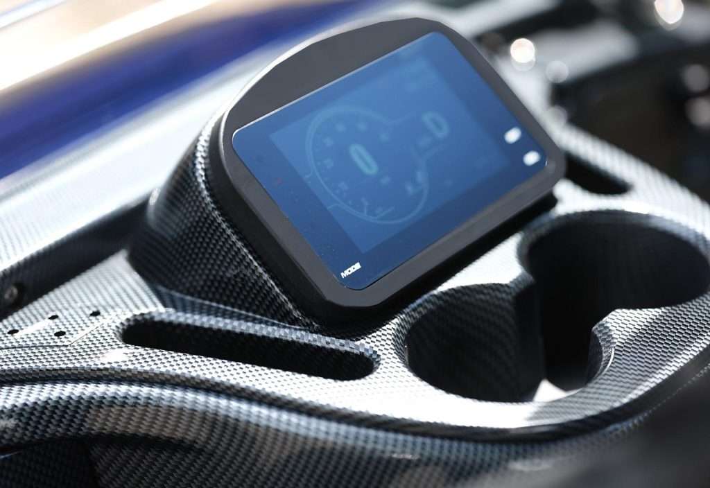 Smartwatch displaying a fitness app on a car's center console.