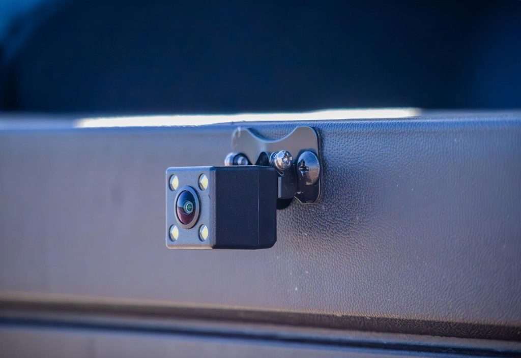 A close-up of a black security camera mounted on a gray surface.