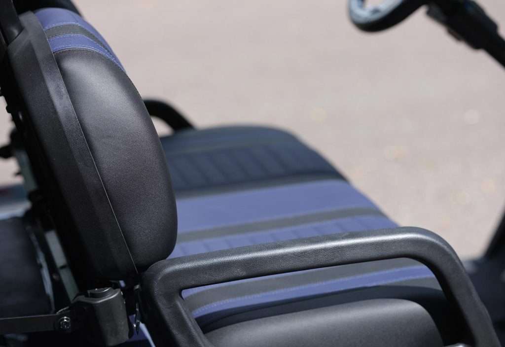 Close-up of a black leather motorcycle seat and backrest.