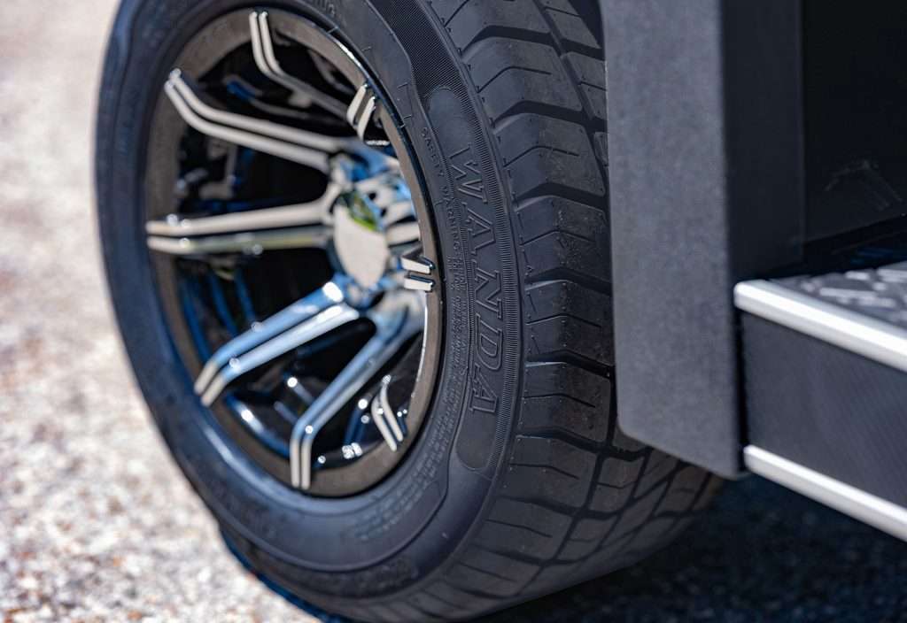 Close-up of a car's alloy wheel and tire with detailed tread.