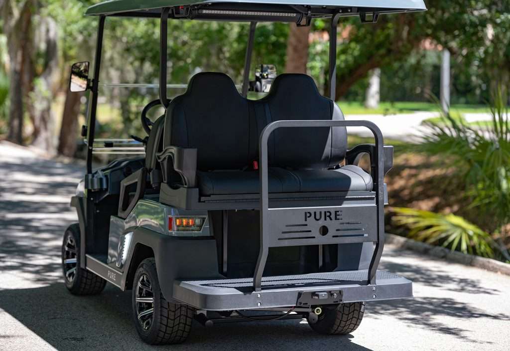 A black golf cart parked outdoors on a sunny day.