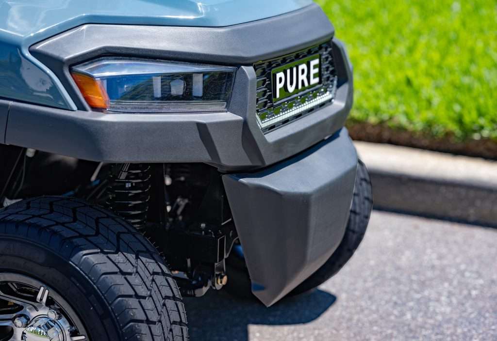 Close-up of a vehicle's front with a 'PURE' license plate.