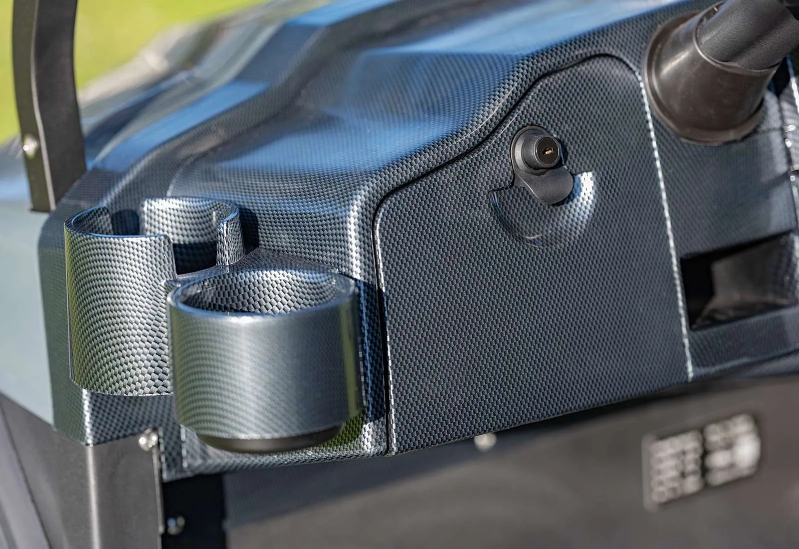 Close-up of a metallic mechanical part with screws and a textured grip.