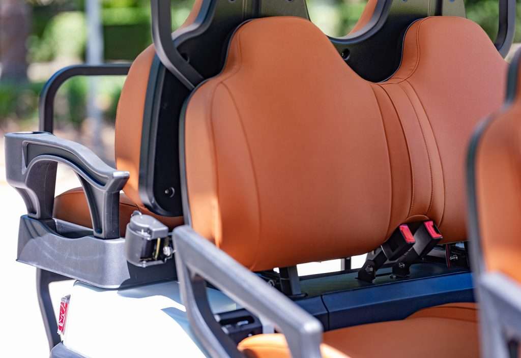 Close-up of a brown leather car seat with ergonomic design.