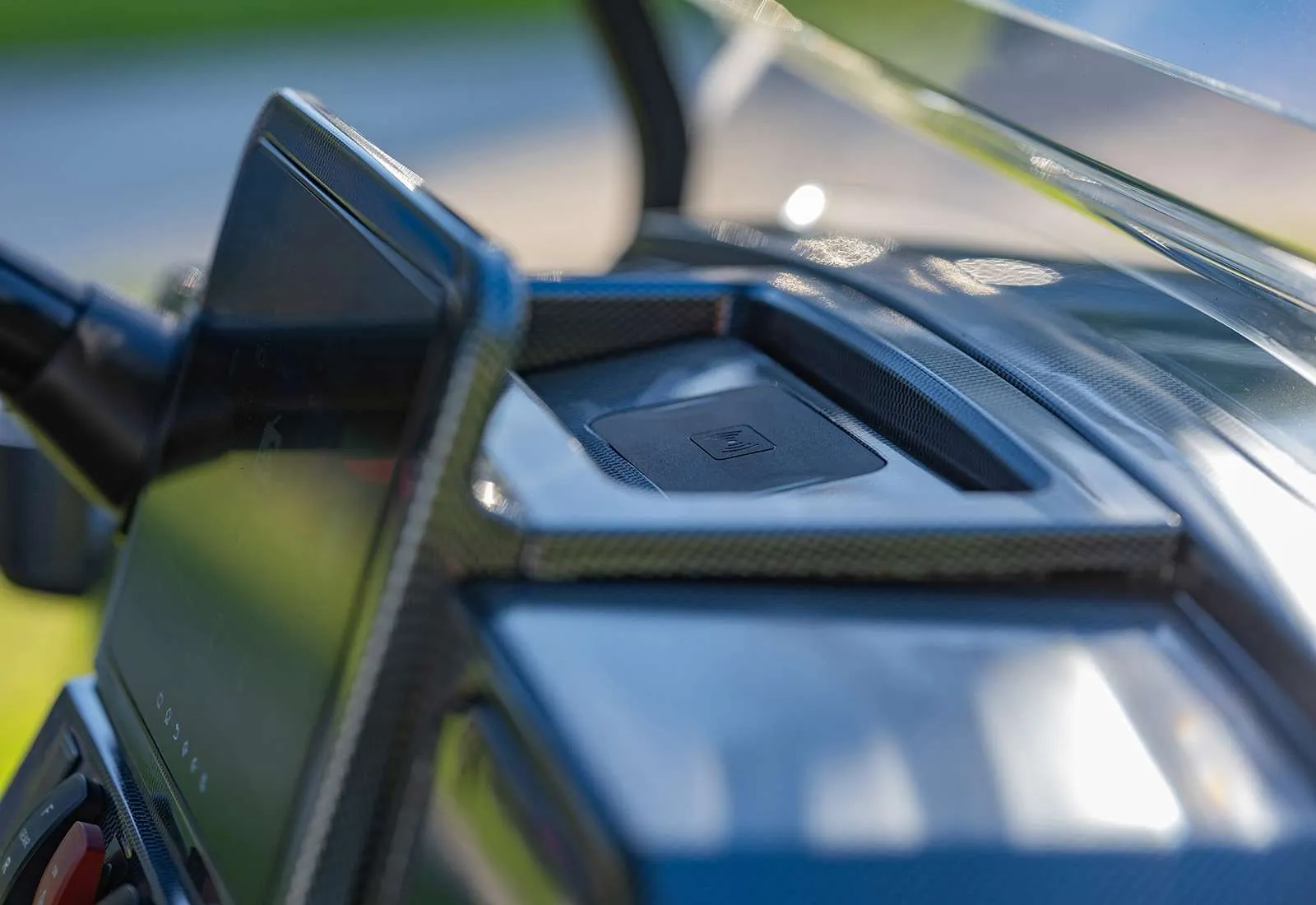 Close-up of a car's dashboard with a focus on the speaker and control panel.