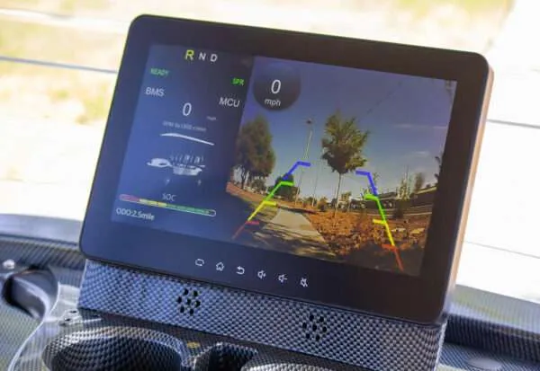 Car dashboard screen showing GPS navigation and music controls.