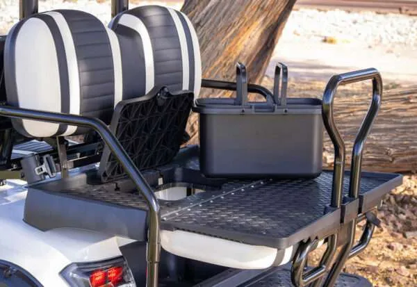 Utility vehicle bed with two black cases and a netted storage pouch.