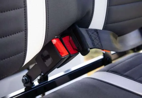 Close-up of a seatbelt buckle in a car seat.