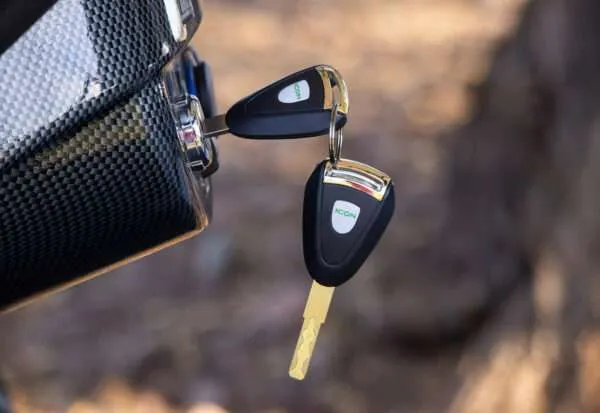 A close-up of car keys in a black leather bag.