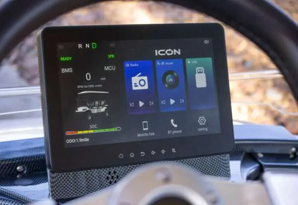 Close-up of an ICOM digital display on a motorcycle dashboard.