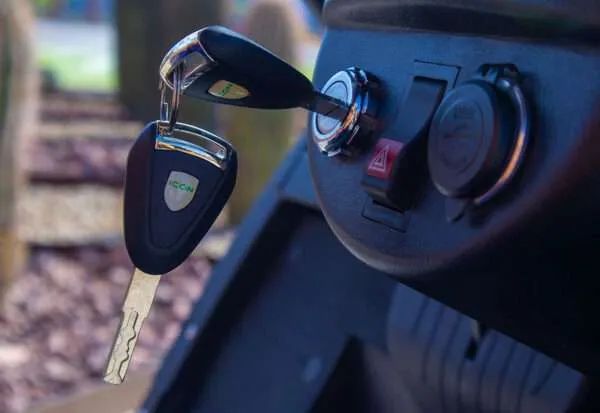 Close-up of car key inserted in the ignition.