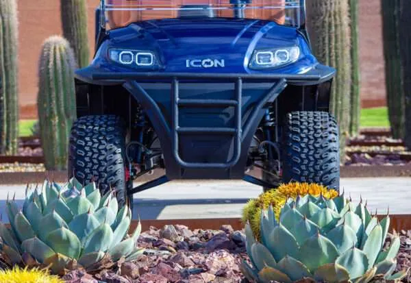 A blue ICON off-road vehicle parked outdoors.
