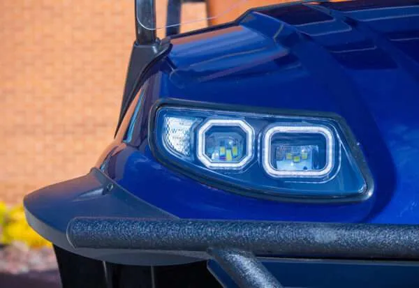 Close-up of a modern blue vehicle's headlight design.