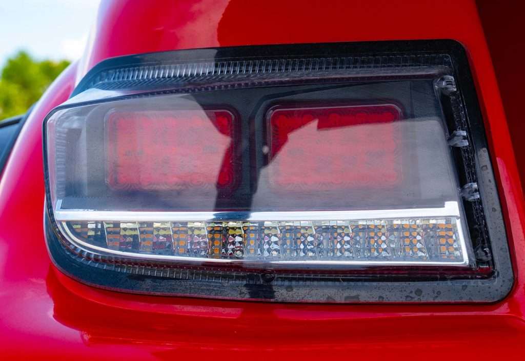Close-up of a car's red and black taillight with LED elements.