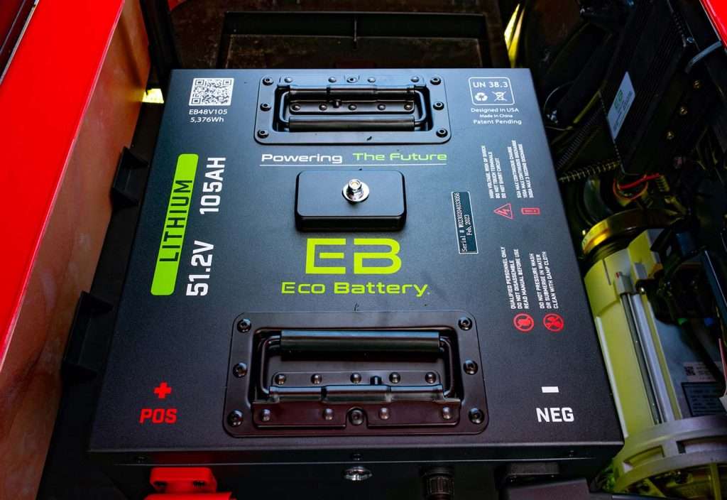 A green battery charger labeled GB Smart Battery with slots for different battery types.