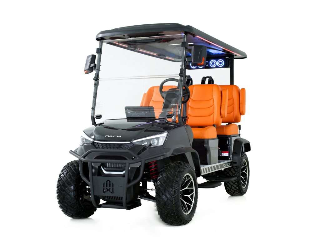 Black and orange electric golf cart with a roof and off-road tires.