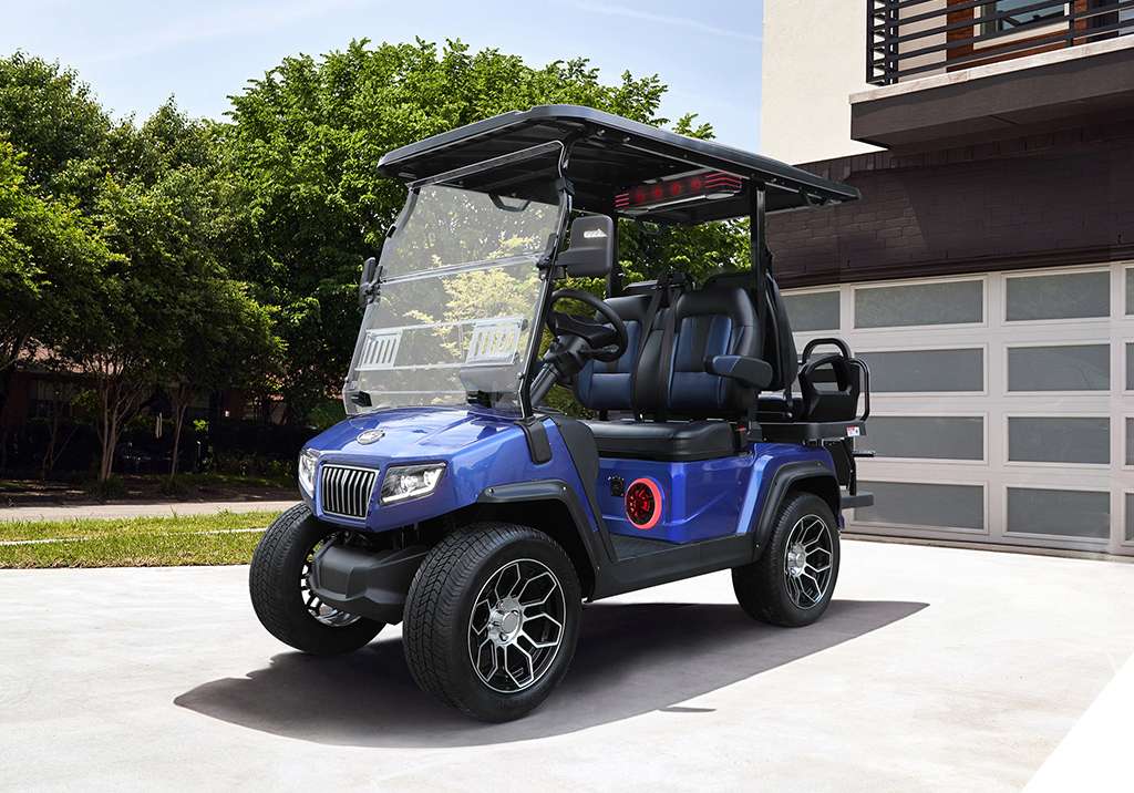 A blue golf cart parked outside a modern house.