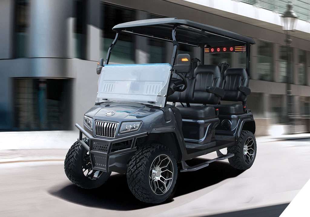 Black electric golf cart with off-road tires in urban setting.