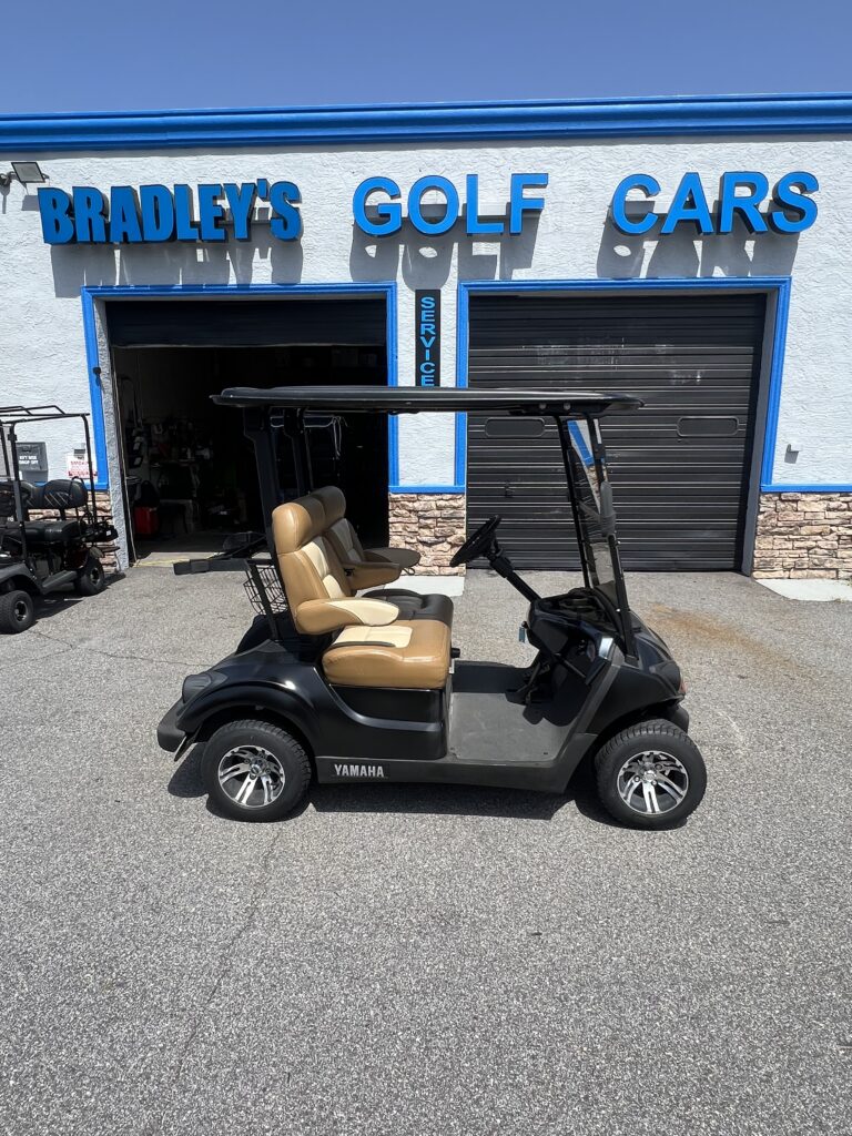 Black Yamaha golf cart with tan seats