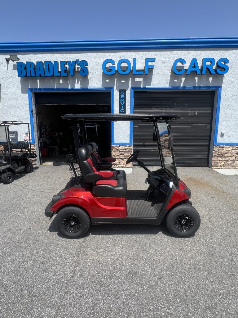 Red four-seat golf cart outside Bradley's Golf Cars