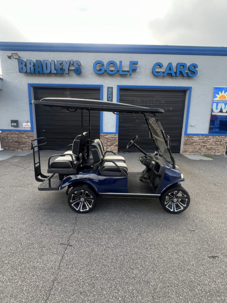 Blue four-seat golf cart outside dealership