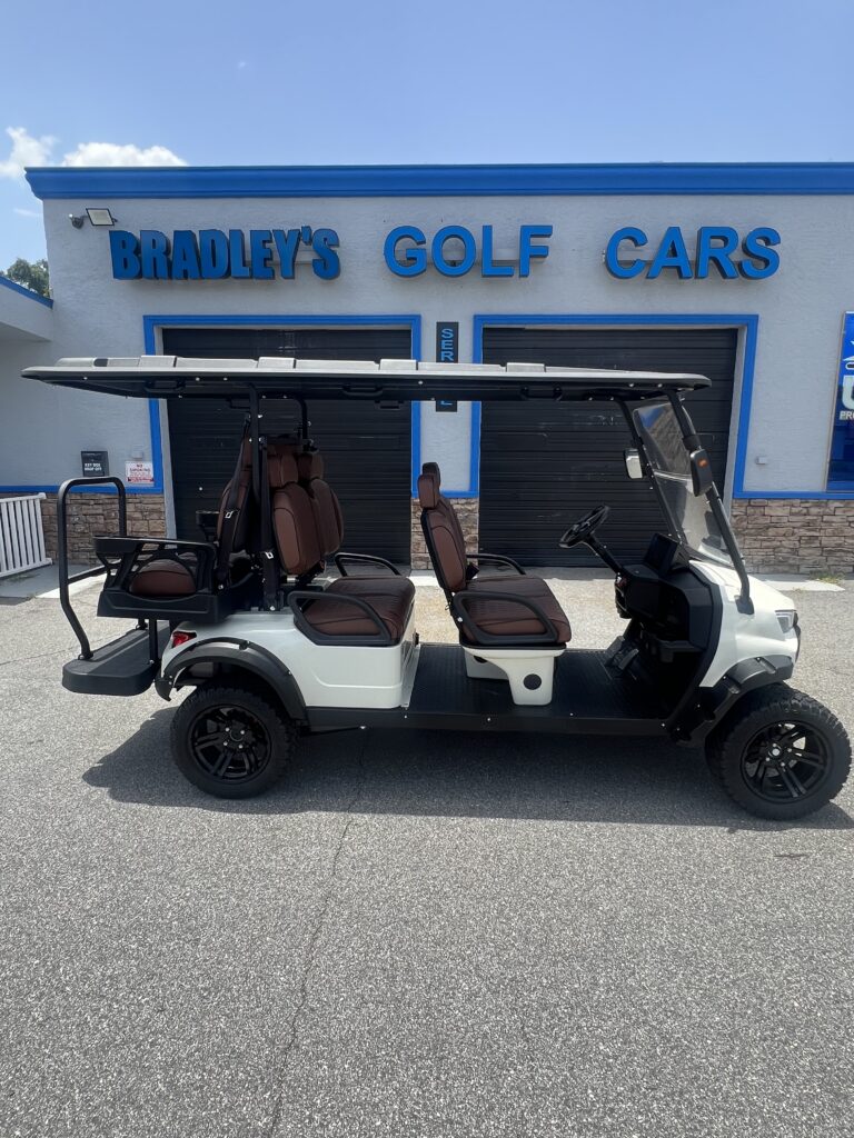 White extended golf cart with brown seats
