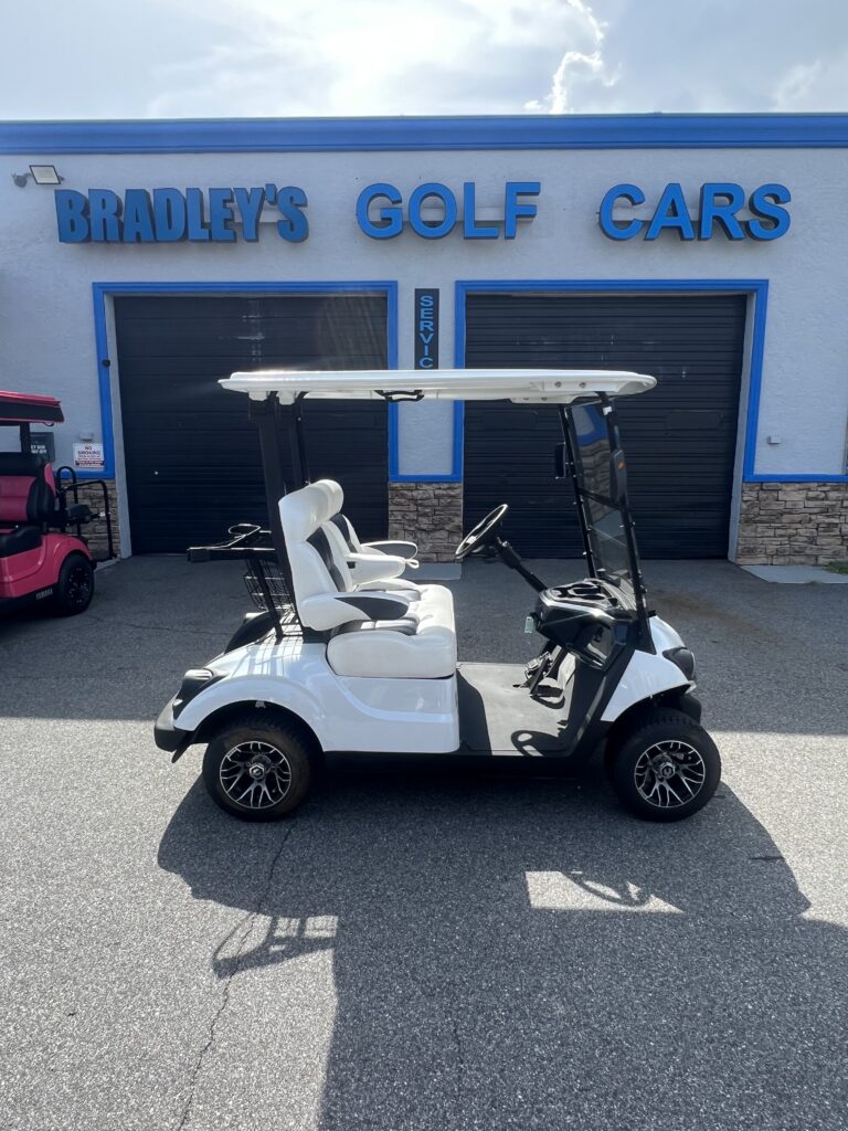 White golf cart outside Bradley's Golf Cars